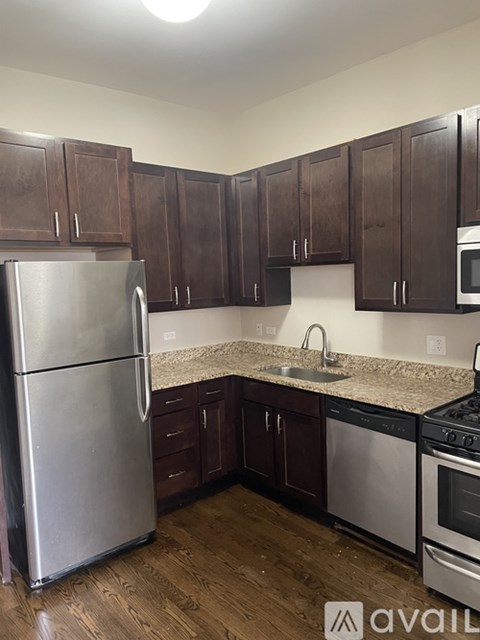 A kitchen with wooden cabinets and stainless steel appliances.