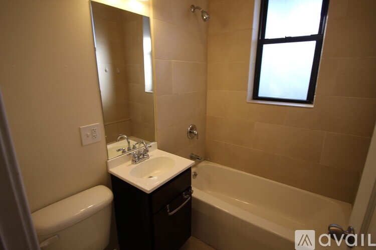 A bathroom with a white sink and a bathtub.