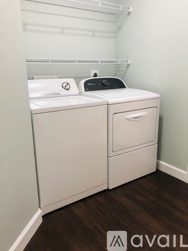 A white washer and dryer in a small room.