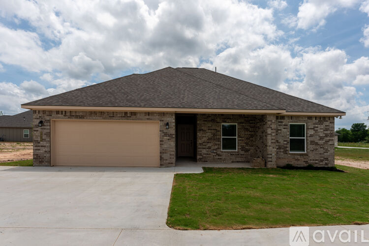 A house with a garage door and a stone wall.