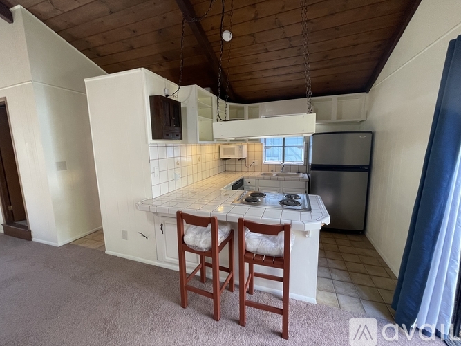A kitchen with a wooden ceiling and a white countertop.