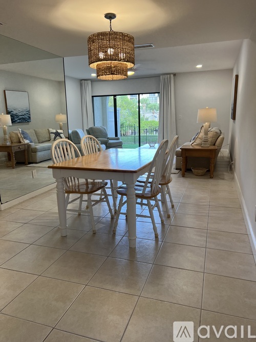 A dining room with a table set for four.
