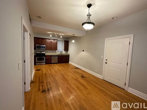 A kitchen with wooden floors and white walls.