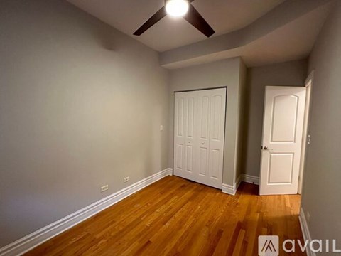 A room with a wooden floor and a ceiling fan.