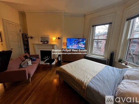 A bedroom with a large bed and a flat screen TV mounted on the wall.