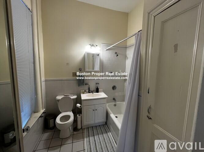 A bathroom with a toilet, sink, and bathtub.