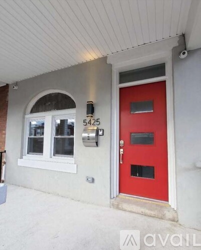 A red door with a mailbox on the wall.