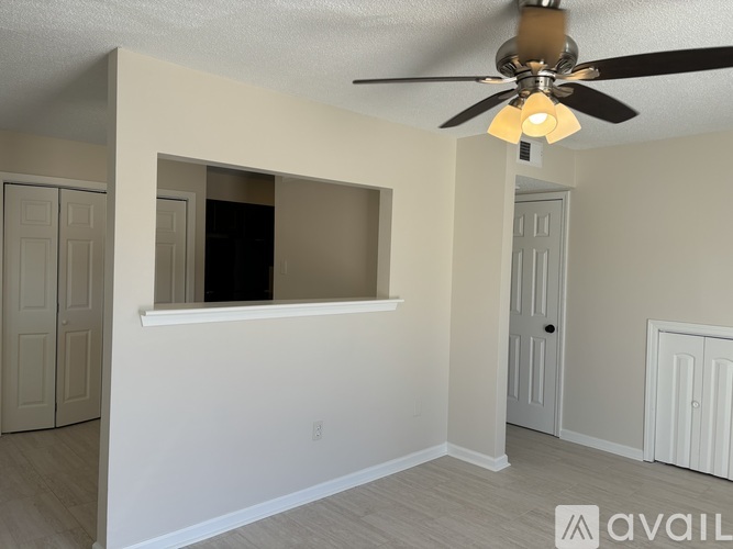 A room with a ceiling fan and a window.