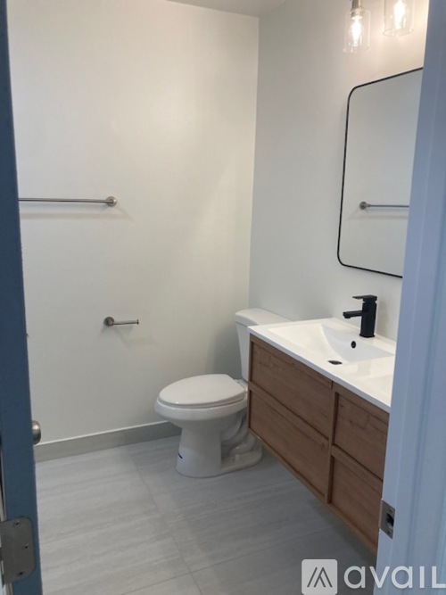 A white toilet sits next to a sink in a bathroom.