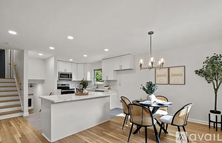 A modern kitchen with a dining table set for four.