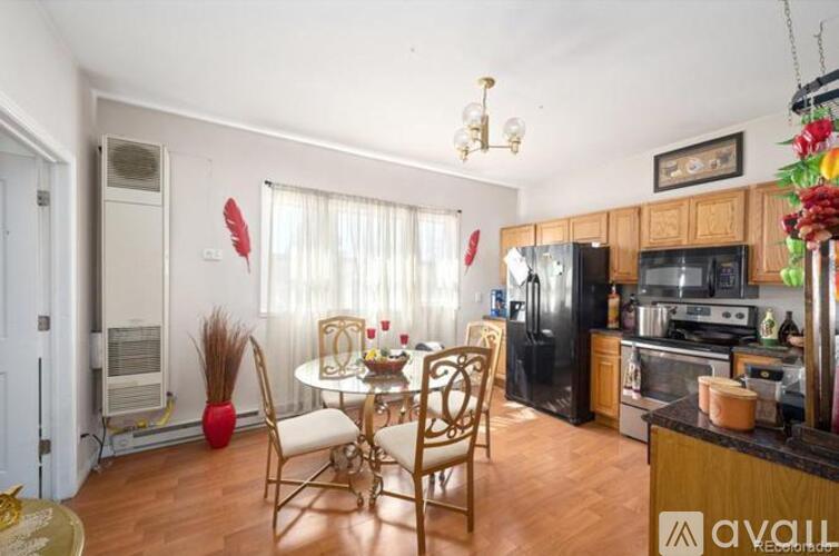 A kitchen with a dining table and chairs.