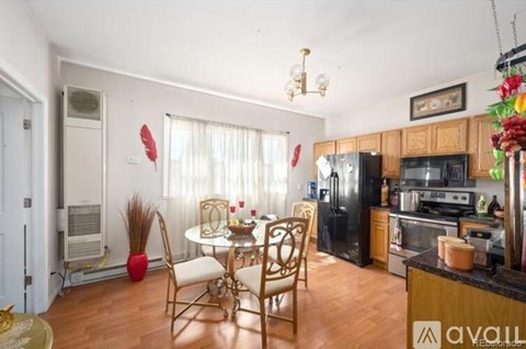A kitchen with a dining table and chairs.