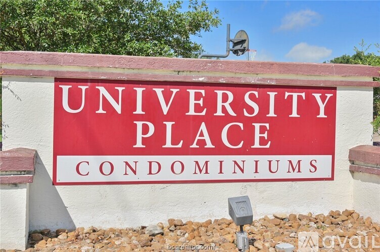 A sign that says University Place Condominiums in front of a building.