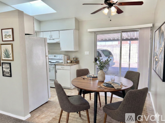 A modern kitchen with a dining table set for four.