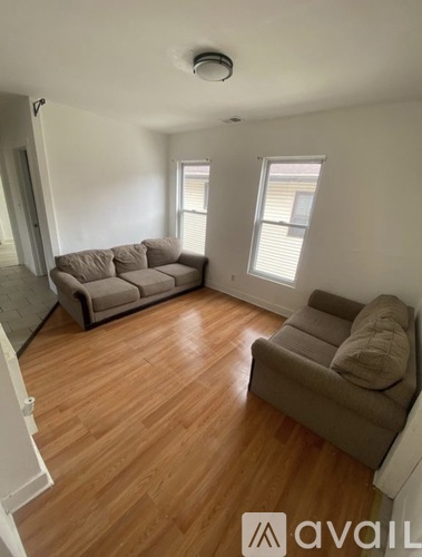 A living room with a couch and a sofa.