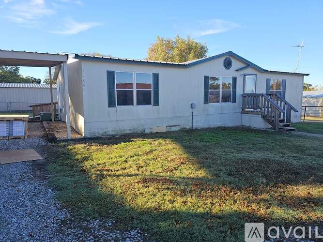 A mobile home with a porch and a covered patio area.