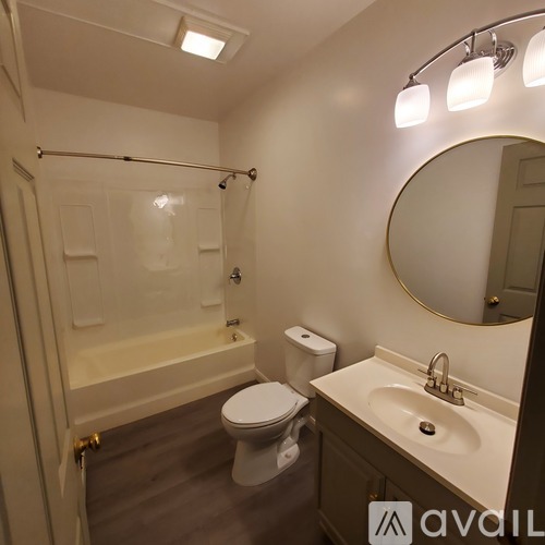 A bathroom with a toilet, sink, and shower.