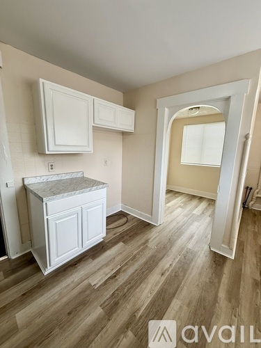 A kitchen area with a counter and cabinets.