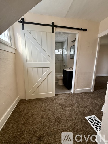 A bathroom with a toilet and a sliding door.