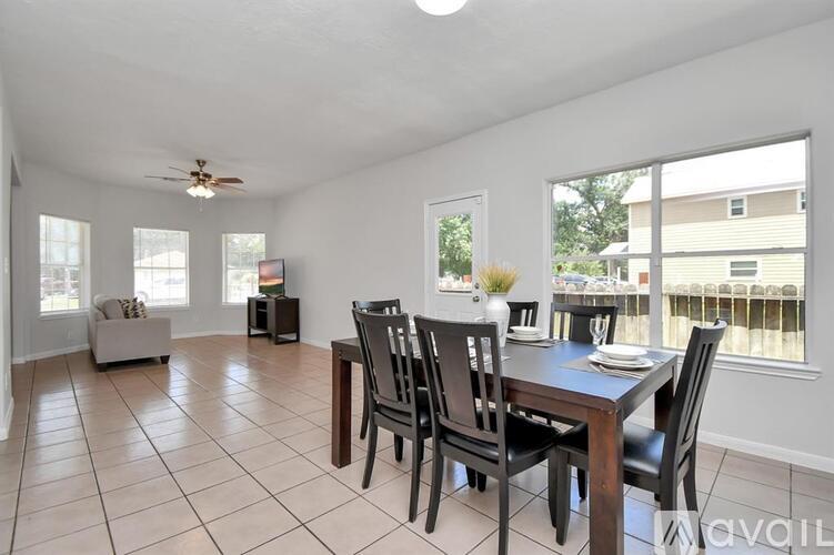 A dining room with a table and chairs.