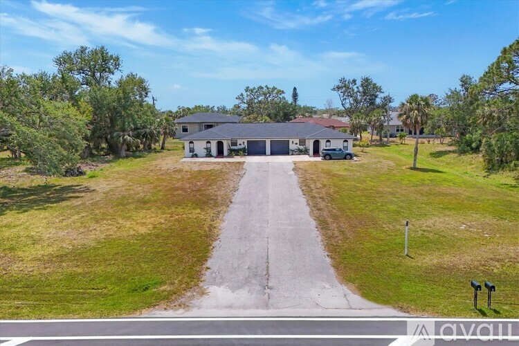 A house with a driveway in front of it is for sale.