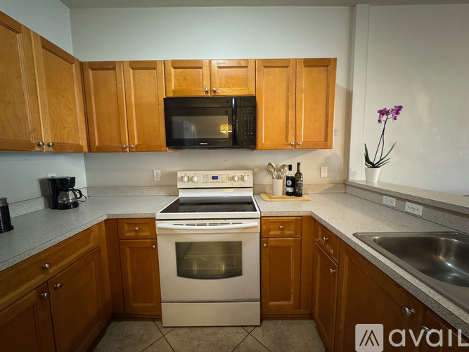 A kitchen with wooden cabinets and a stainless steel sink.