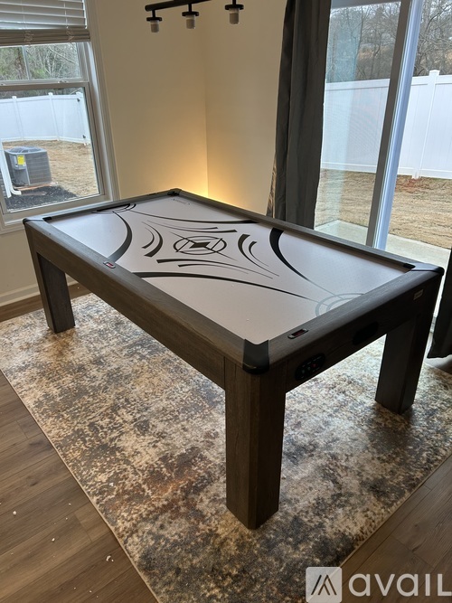A pool table with a black cloth and a design on it.