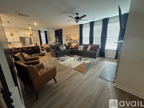 A living room with a grey couch and a brown armchair.