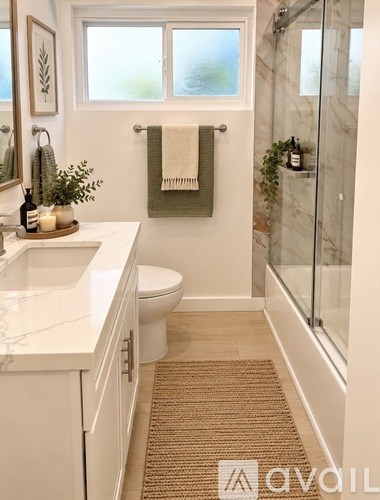 A room with a wooden floor and a wall-mounted air conditioner unit.