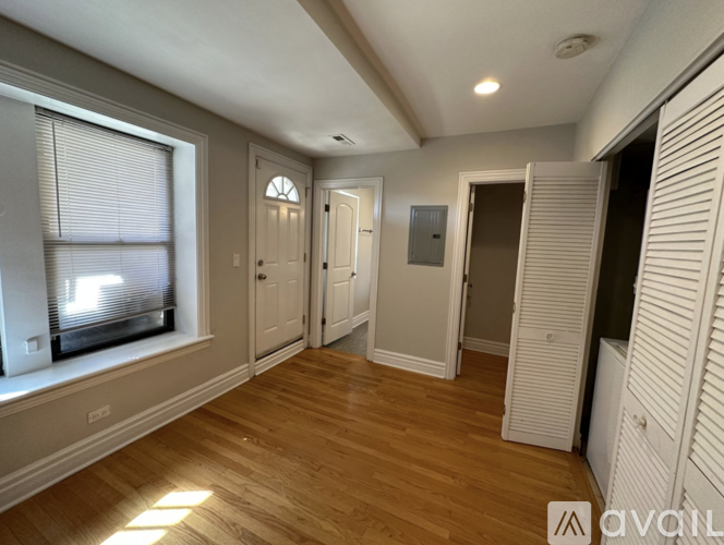 A bedroom with a bed, a ceiling fan, and a cardboard box on the floor.