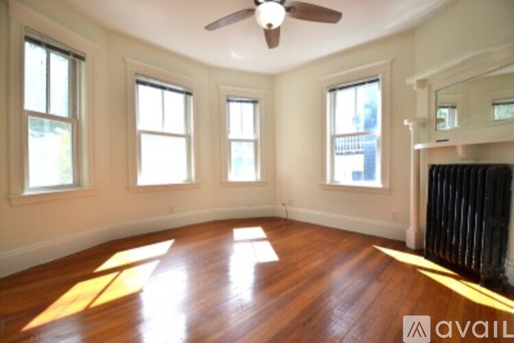 A room with wooden floors and a ceiling fan.