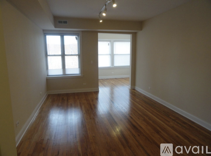 A room with wooden floors and a window.