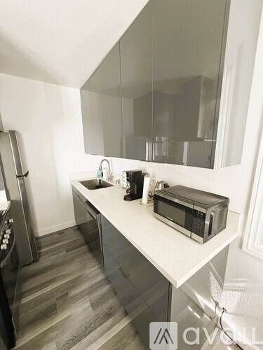 A modern kitchen with a microwave on the counter.
