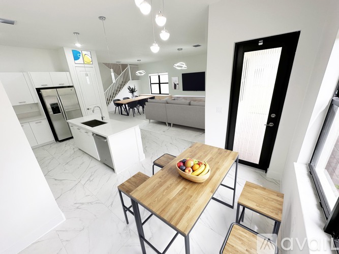 A modern kitchen with a dining table and chairs.