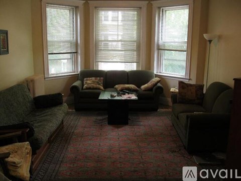 A living room with a couch, chair, and coffee table.
