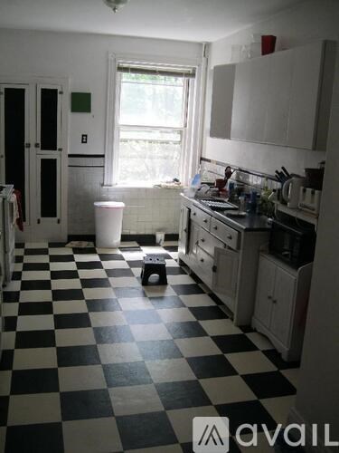 A black and white checkered floor in a kitchen.