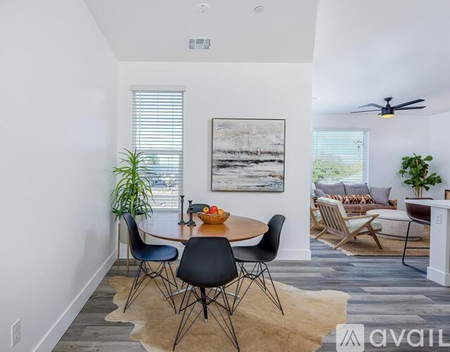 A dining room with a table and chairs.