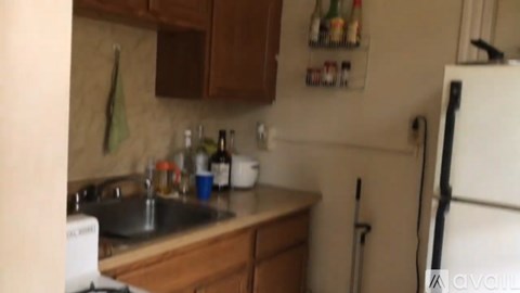 A kitchen with a sink and a refrigerator.