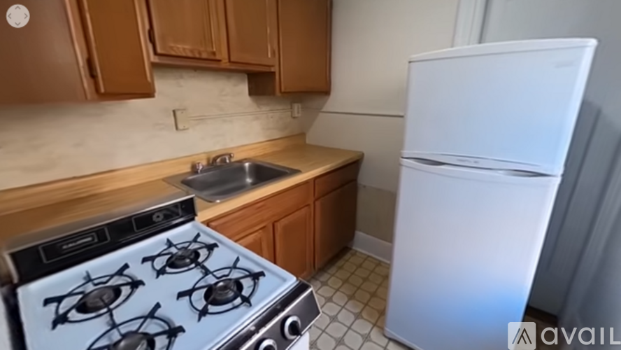 A kitchen with a white fridge and a black stove.