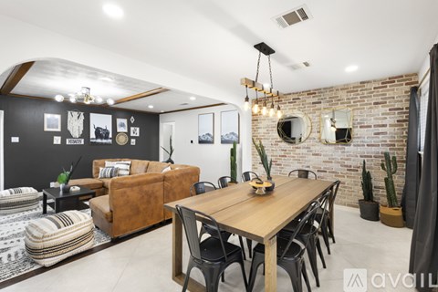 A modern living room with a wooden dining table and chairs.