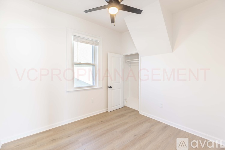 A room with a ceiling fan and a window.