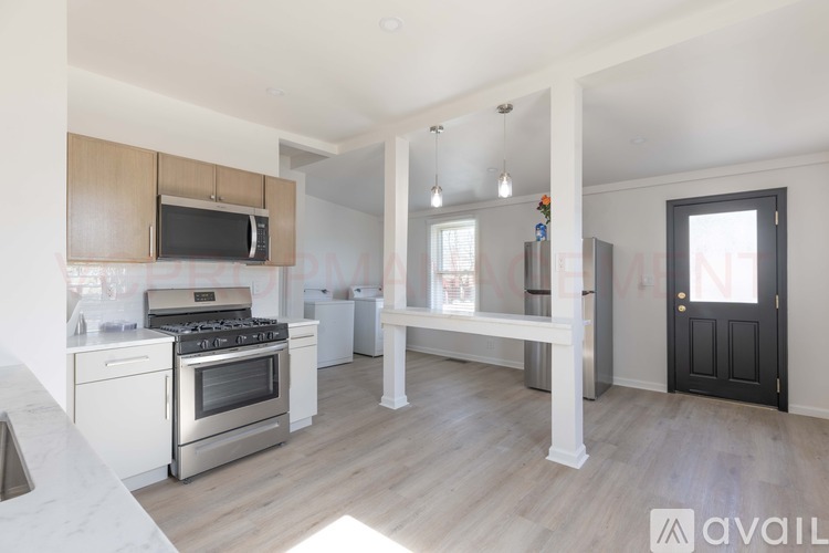 A kitchen with a stove top oven and microwave.
