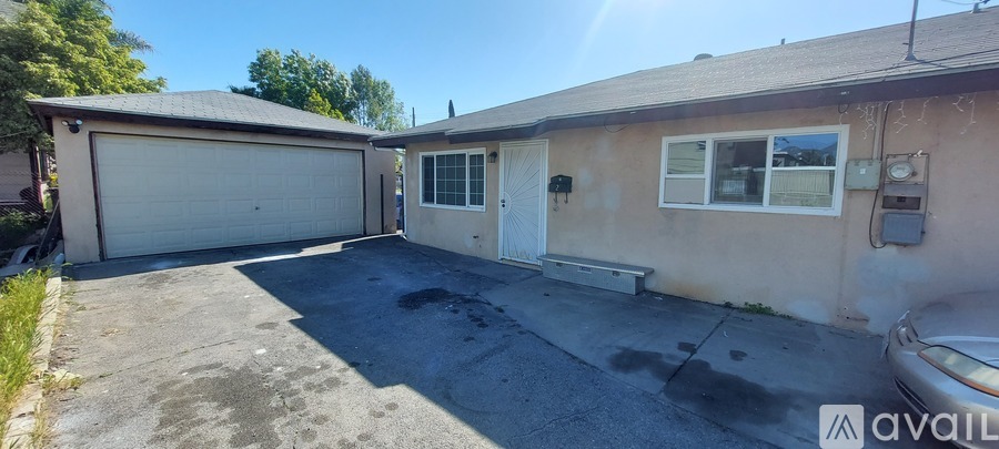 A house with a garage and a car parked in front.