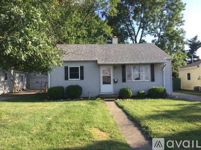 A house with a white door and a small front yard.