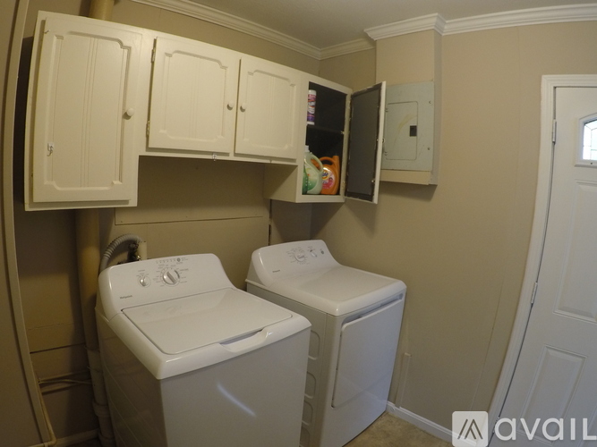 A small laundry room with a washer and dryer.