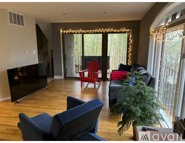 A living room with a blue couch and a red chair.