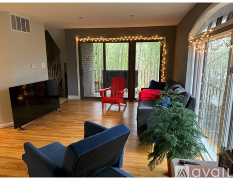 A living room with a blue couch and a red chair.