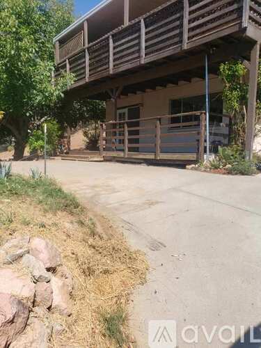 A house with a balcony and a garage door.