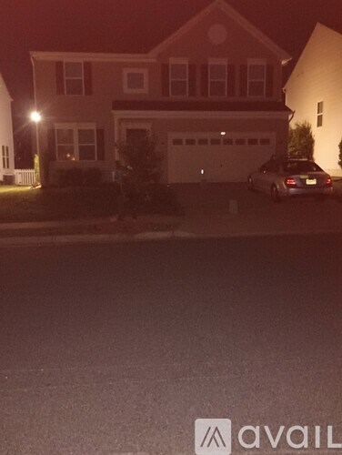 A house with a car parked in front of it.
