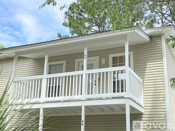 A balcony of a house with a white railing.